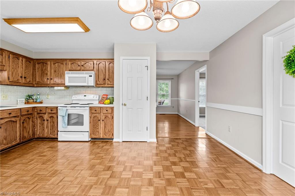 3603 Fieldview Road Pleasant Garden, NC 27313 - Photo 11 of 31 Large eat in kitchen has pantry for storage, attached microwave & parquet flooring.