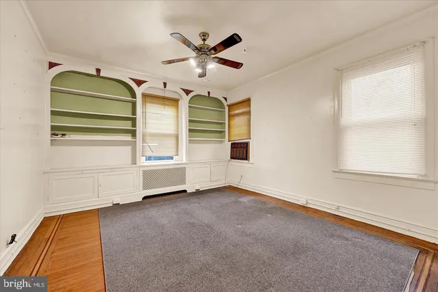 a view of room with windows and ceiling fan