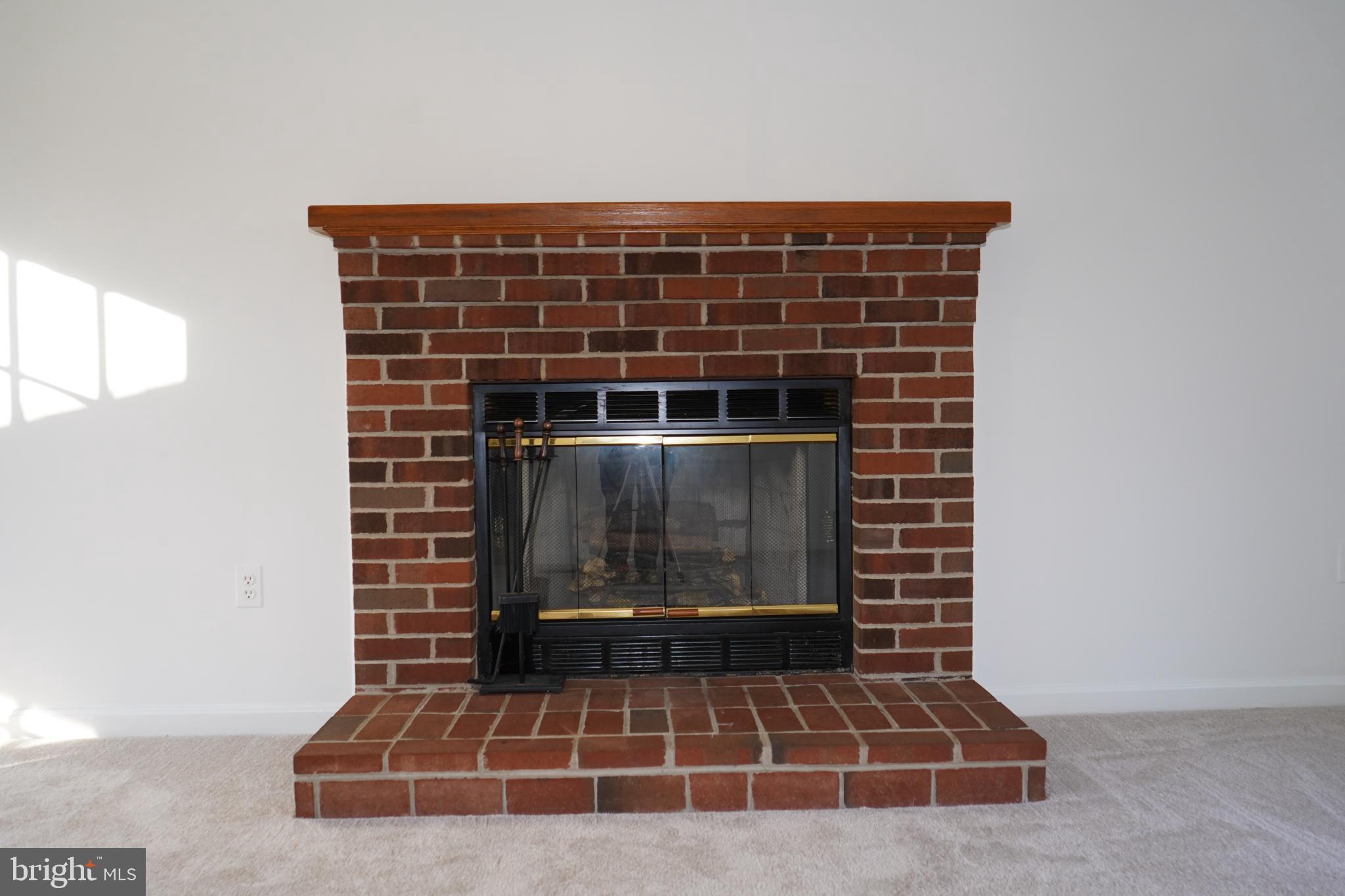 7323 O'Keefe Road Bealeton, VA 22712 - Photo 13 of 26 Cozy brick fireplace with warm ambiance.