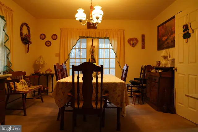 a view of a dining room with furniture and chandelier