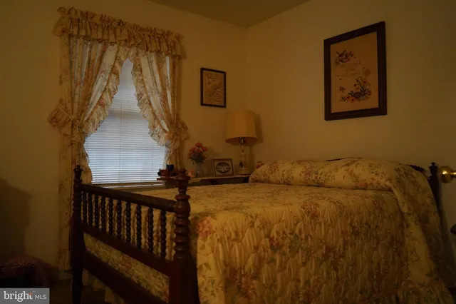 a bedroom with a bed and the view of a small room