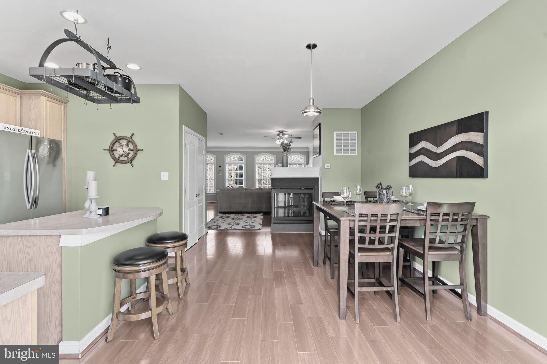 10423 Rifle Road Bristow, VA 20136 - Photo 11 of 39 a view of a dining room with furniture wooden floor and chandelier