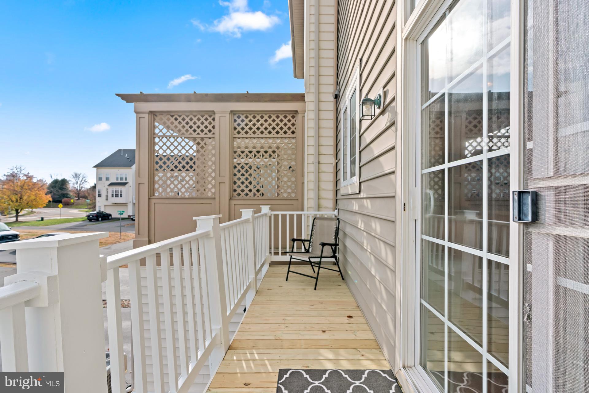 10423 Rifle Road Bristow, VA 20136 - Photo 9 of 39 a view of a balcony with wooden floor and fence