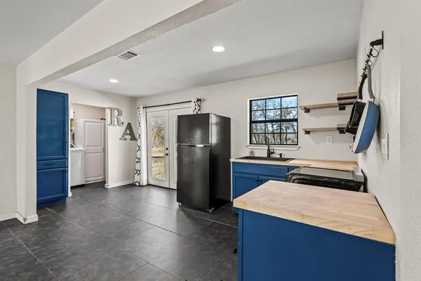 a kitchen with stainless steel appliances granite countertop a refrigerator and a stove