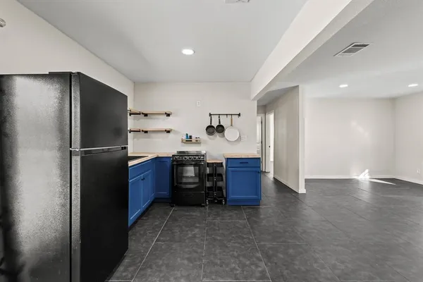 a kitchen with stainless steel appliances kitchen island granite countertop a refrigerator and a stove
