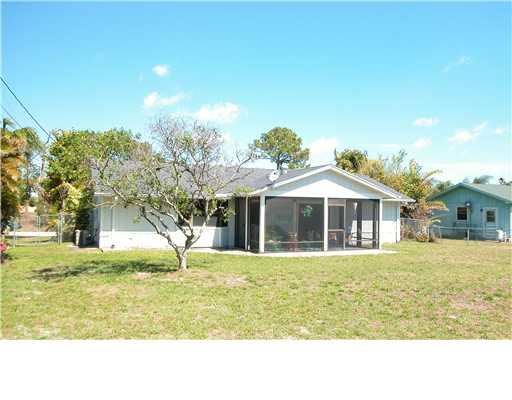 938 Southwest Bay State Road Port St. Lucie, FL 34953 - Photo 12 of 16 a front view of a house with a yard