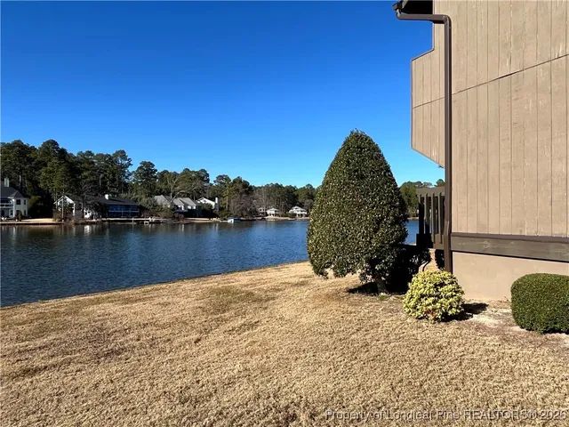 a view of a lake with a house in the background