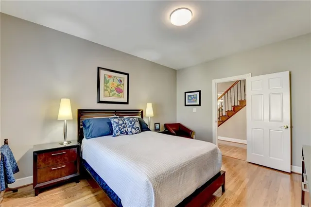 a bed room with two bed and a night stand