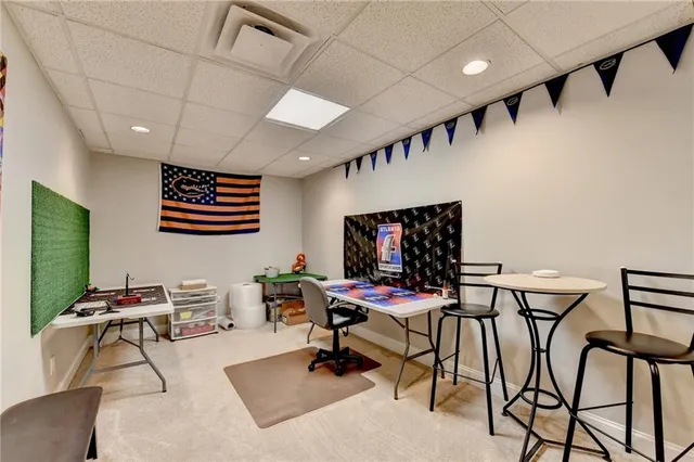 a work room with furniture and a flat screen tv