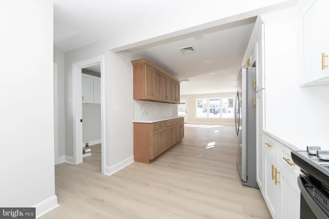 a view of a kitchen cabinets and a wooden floor