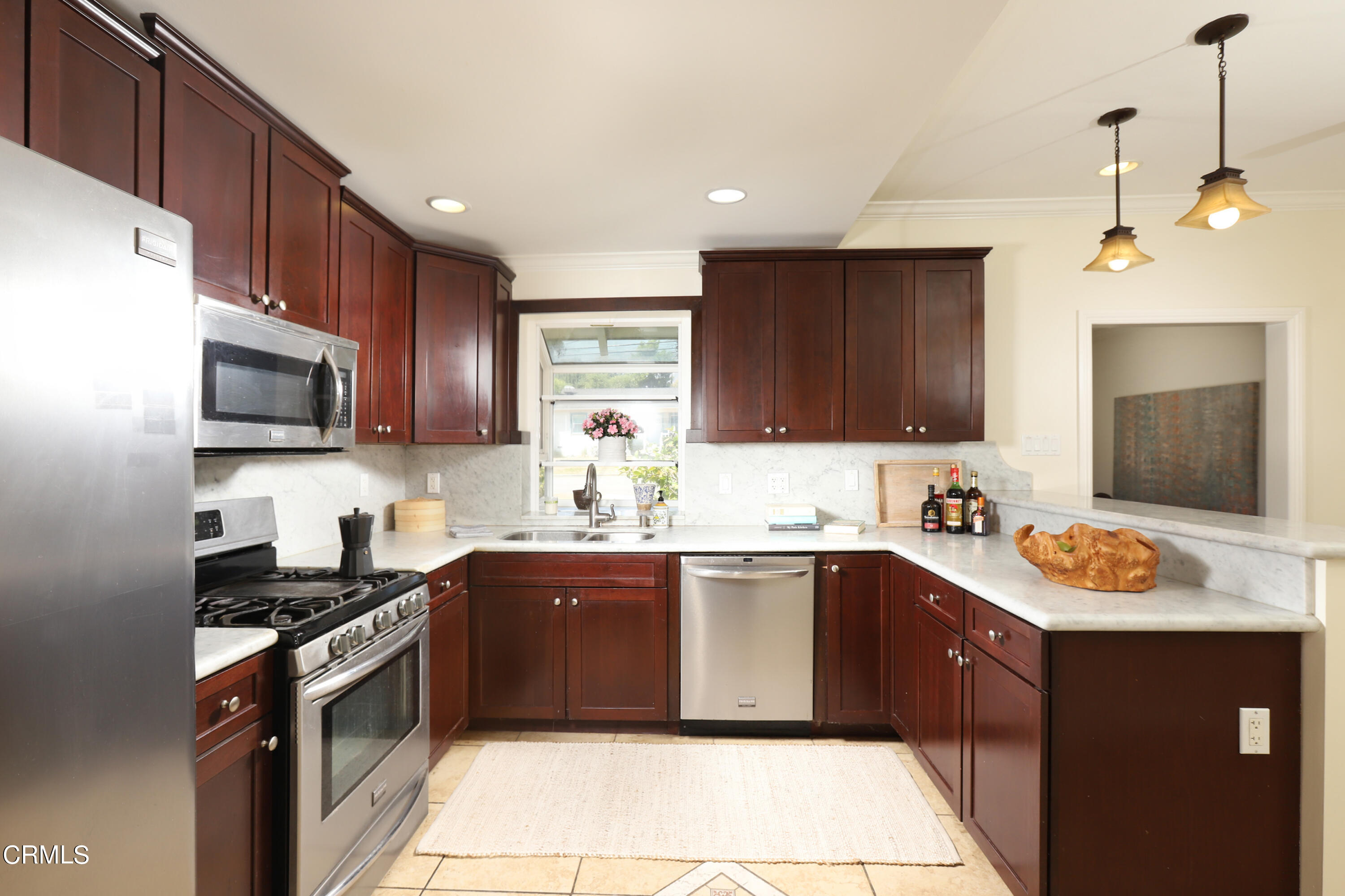 1062 Morada Place Altadena, CA 91001 - Photo 7 of 24 a kitchen with a sink stove top oven and wooden cabinets
