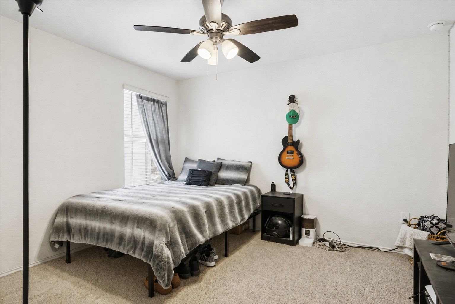 14904 Shalestone Way Manor, TX 78653 - Photo 24 of 32 a bedroom with a bed and a chandelier