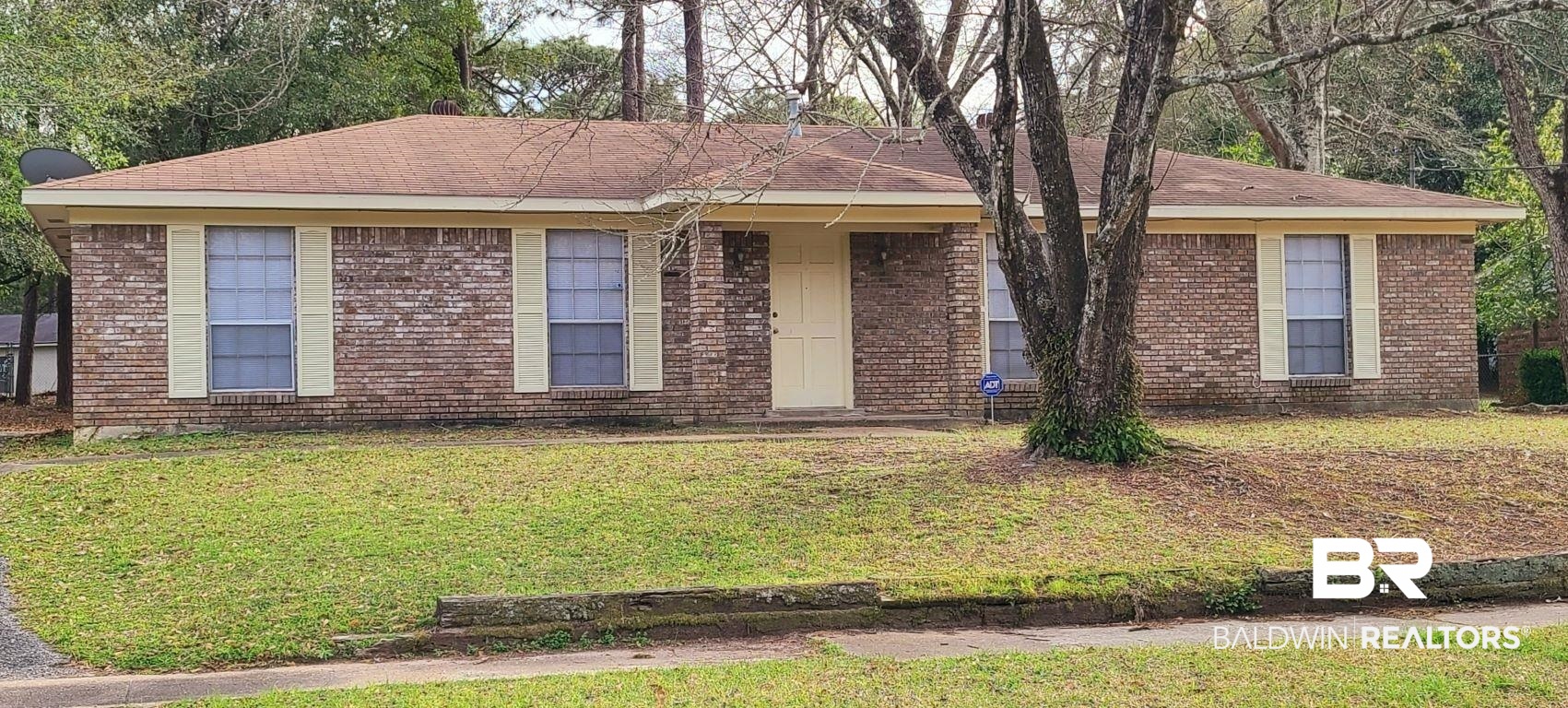 5305 Wilhelm Drive Mobile, AL 36618 - Photo 1 of 16 Ranch-style home featuring brick siding and a front yard