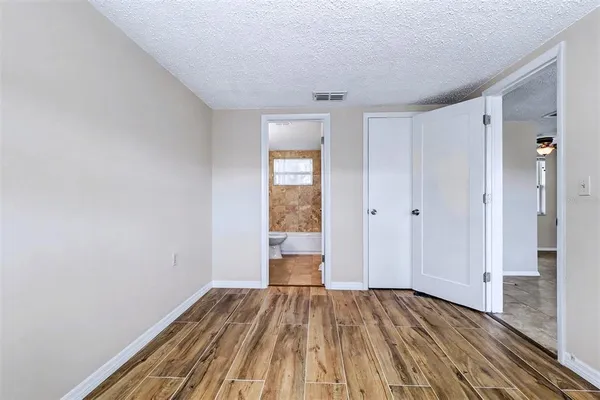 a view of a room with wooden floor and bench