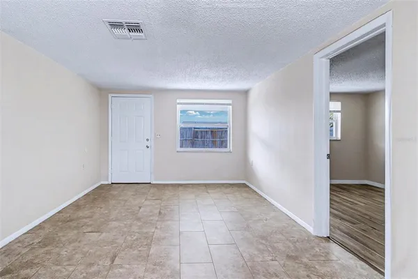 an empty room with windows and closet