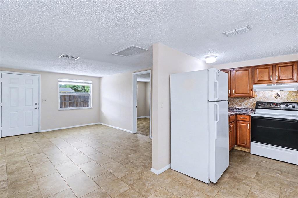 5441 Oceanic Road Holiday, FL 34690 - Photo 6 of 13 a view of a kitchen with a sink stove refrigerator and windows