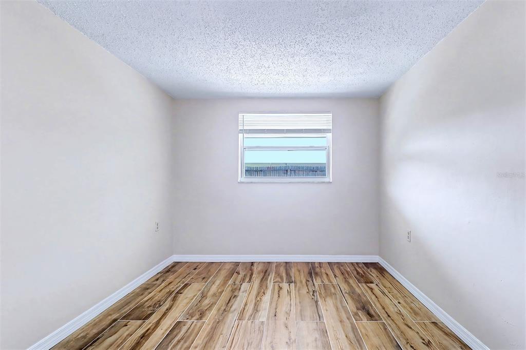 5441 Oceanic Road Holiday, FL 34690 - Photo 9 of 13 a view of a room with wooden floor and window