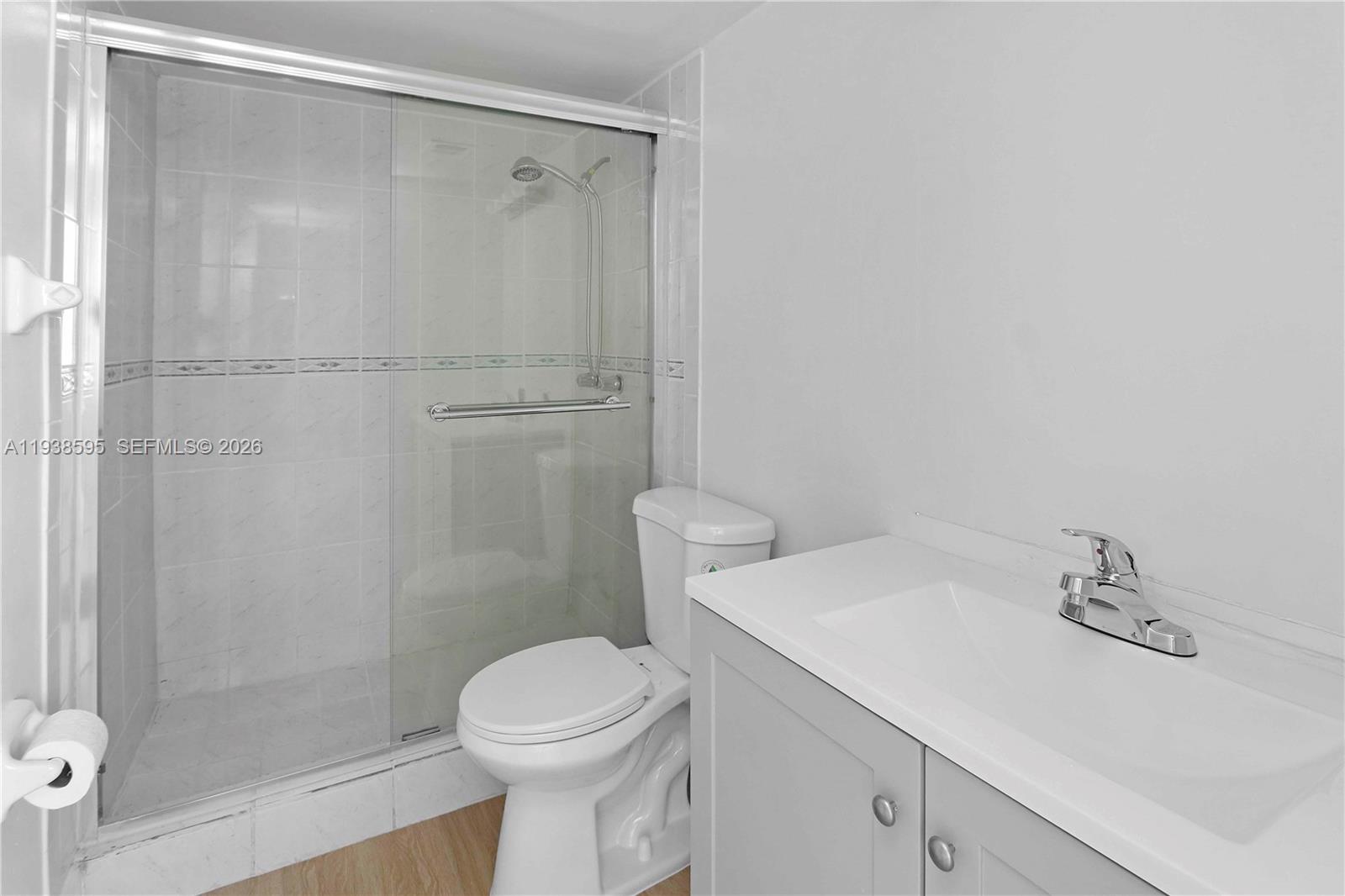 8309 Southwest 142nd Avenue, Unit G112 Miami, FL 33183 - Photo 11 of 28 a bathroom with a sink a toilet and shower