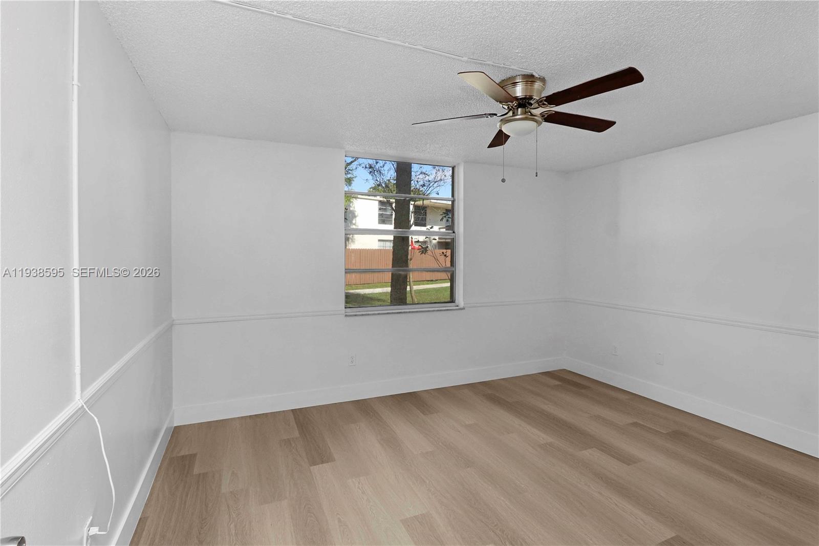 8309 Southwest 142nd Avenue, Unit G112 Miami, FL 33183 - Photo 14 of 28 an empty room with a window and a ceiling fan