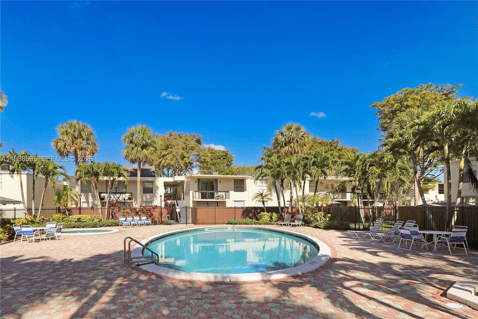 8309 Southwest 142nd Avenue, Unit G112 Miami, FL 33183 - Photo 25 of 28 a swimming pool with outdoor seating and yard