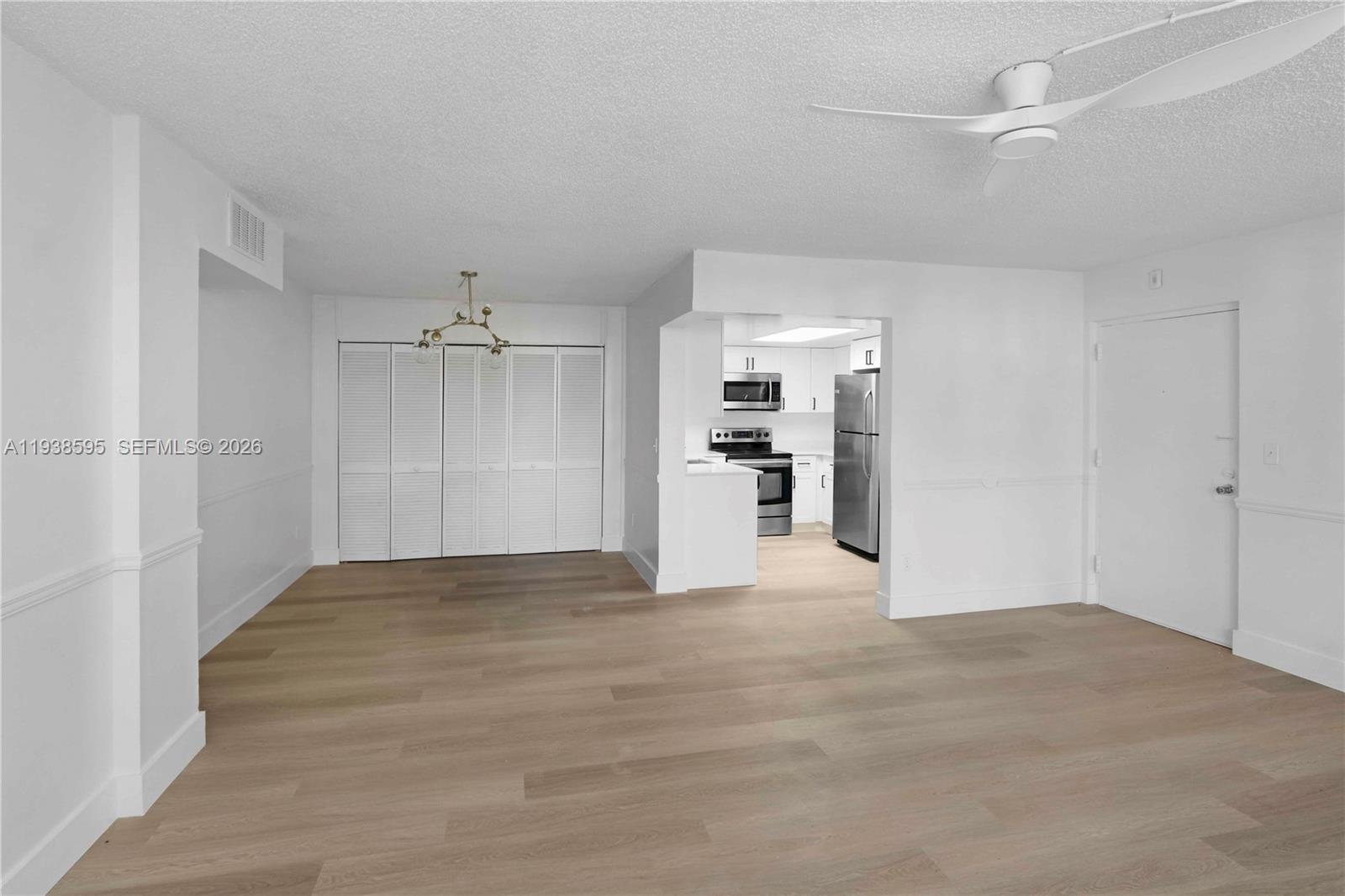 8309 Southwest 142nd Avenue, Unit G112 Miami, FL 33183 - Photo 6 of 28 a view of empty room with wooden floor