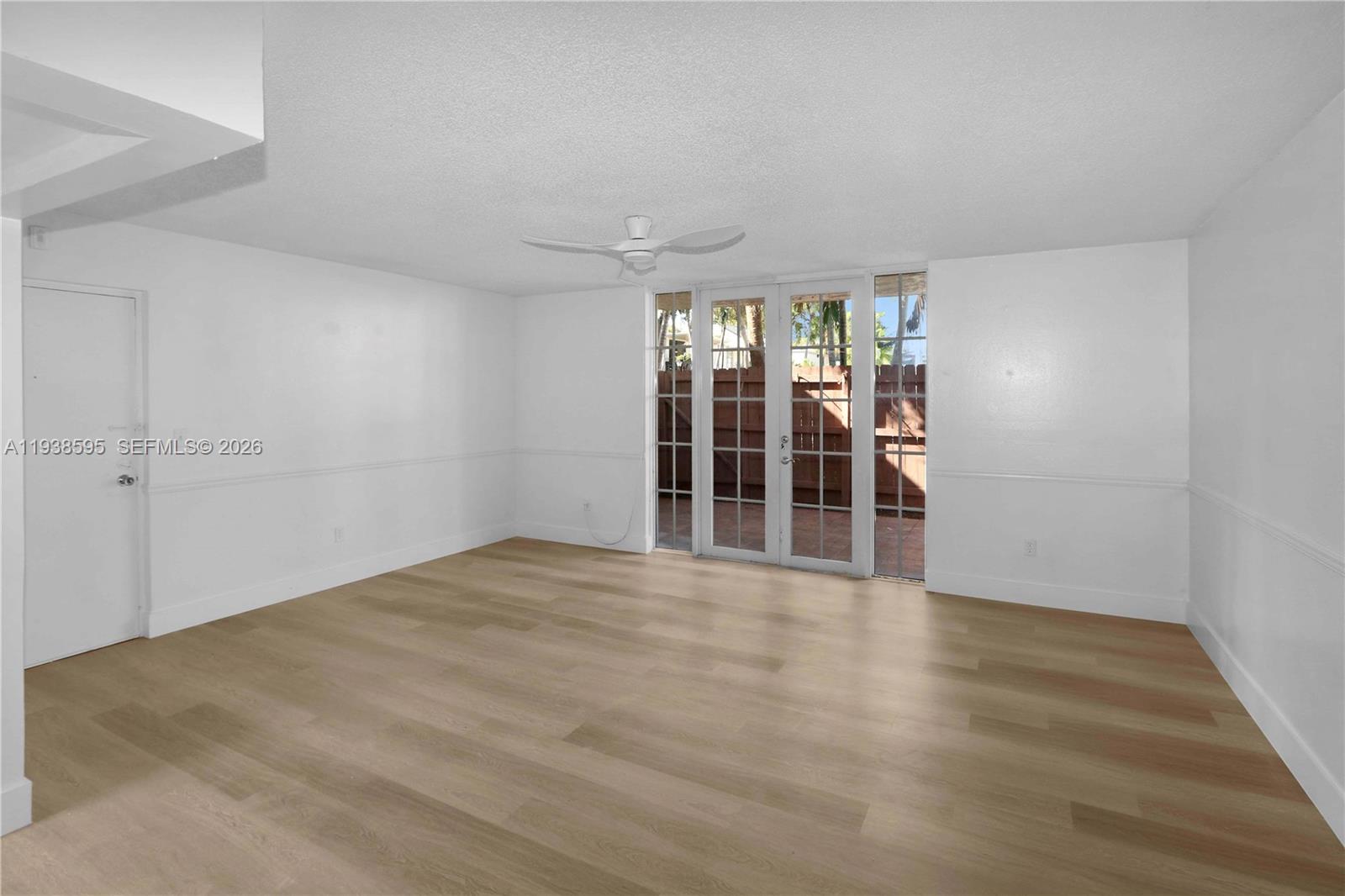 8309 Southwest 142nd Avenue, Unit G112 Miami, FL 33183 - Photo 7 of 28 wooden floor in an empty room