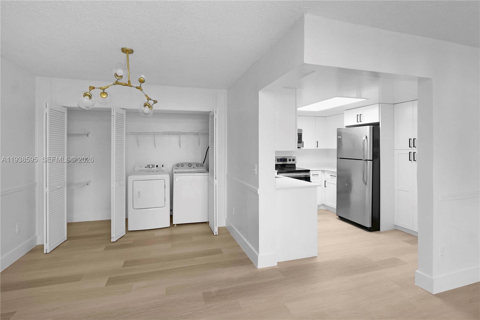 8309 Southwest 142nd Avenue, Unit G112 Miami, FL 33183 - Photo 8 of 28 a view of kitchen refrigerator and cabinets