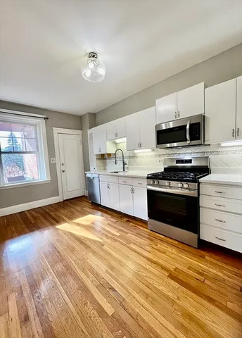 a kitchen with stainless steel appliances granite countertop a stove and a sink