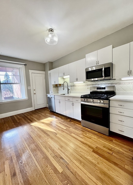 26 Gibbs Street, Unit 5 Brookline, MA 02446 - Photo 1 of 14 a kitchen with stainless steel appliances granite countertop a stove and a sink