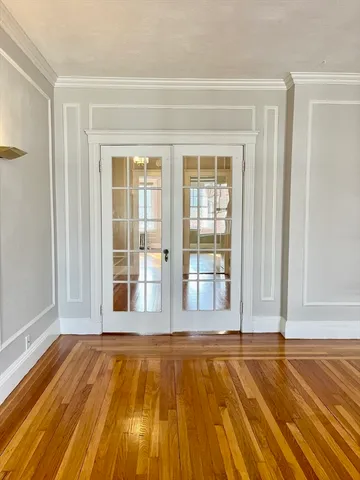 a view of a room with wooden floor and floor to ceiling window