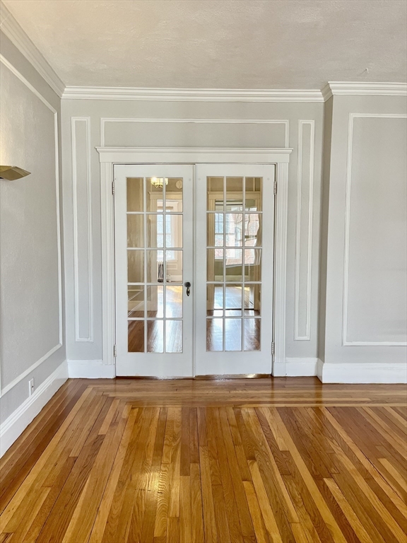 26 Gibbs Street, Unit 5 Brookline, MA 02446 - Photo 4 of 14 a view of a room with wooden floor and floor to ceiling window