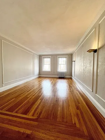 a view of a room with wooden floor and window