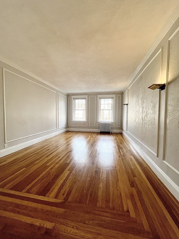 26 Gibbs Street, Unit 5 Brookline, MA 02446 - Photo 5 of 14 a view of a room with wooden floor and window