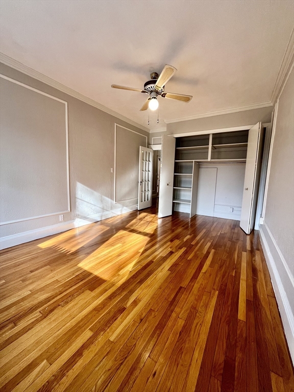 26 Gibbs Street, Unit 5 Brookline, MA 02446 - Photo 6 of 14 a bedroom with a bed and a chandelier