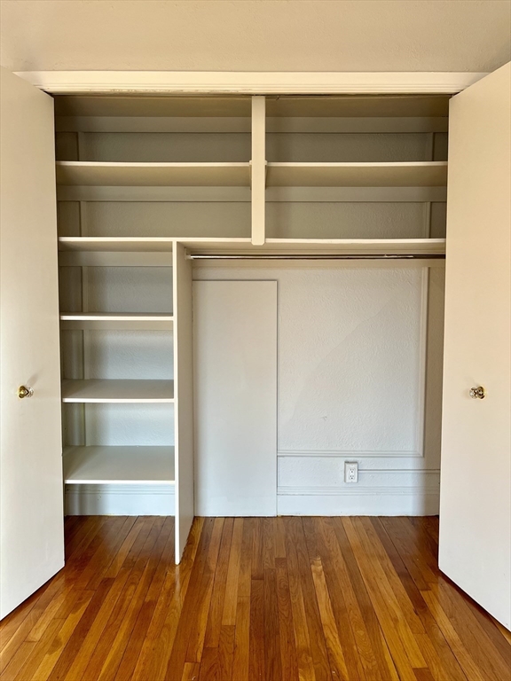 26 Gibbs Street, Unit 5 Brookline, MA 02446 - Photo 7 of 14 a view of a room with wooden floor and cabinet