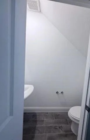 a bathroom with a toilet and a sink
