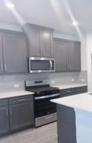a kitchen with granite countertop a stove and a sink
