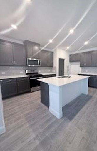 733 Santa Lucia Drive Anna, TX 75409 - Photo 7 of 13 a large kitchen with stainless steel appliances and a sink