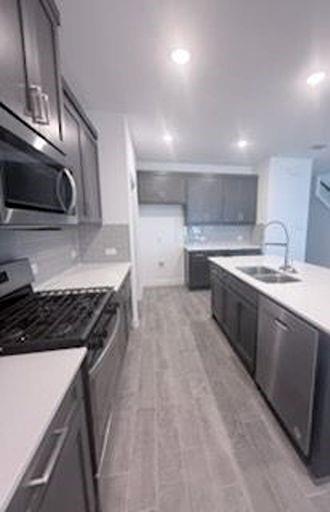 733 Santa Lucia Drive Anna, TX 75409 - Photo 8 of 13 a kitchen with a stove sink and cabinets