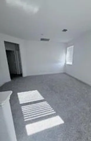 a view of wooden floor and windows in a room