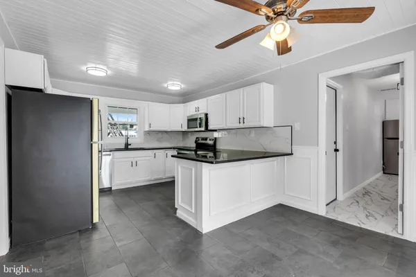 a kitchen with a refrigerator and a sink