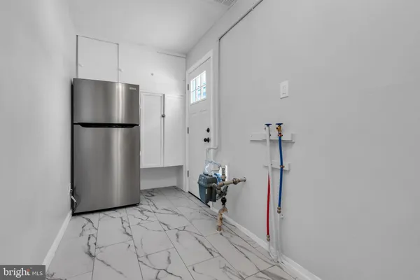 a kitchen with a refrigerator and a stove