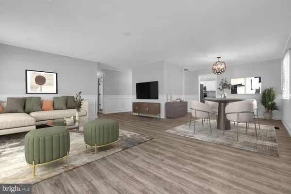 a living room with furniture a flat screen tv and kitchen view