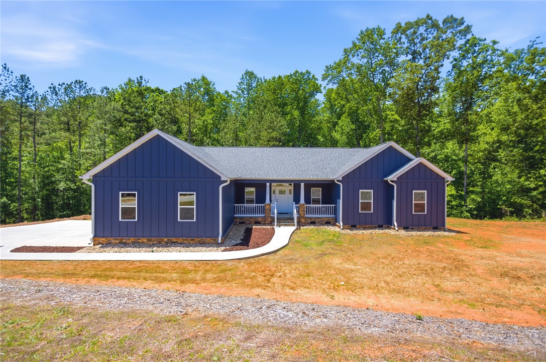912 Watercrest Road West Union, SC 29696 - Photo 1 of 49 This charming home offers a welcoming facade with a classic porch, nestled among lush trees.