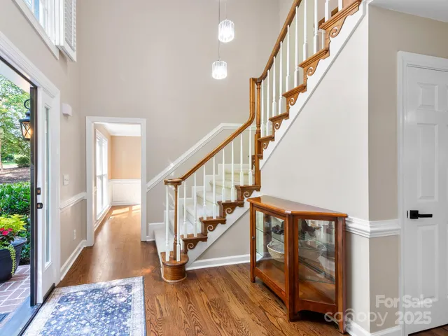a view of entryway with wooden floor and stairs