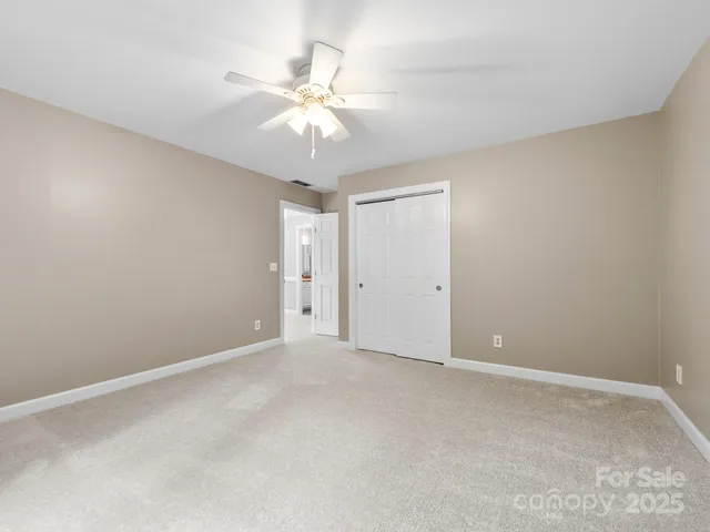 a view of an empty room with a fan