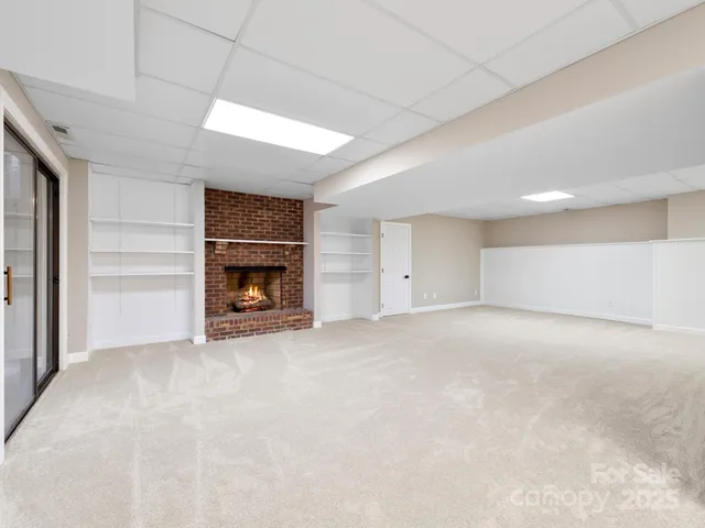a view of empty room with a fireplace