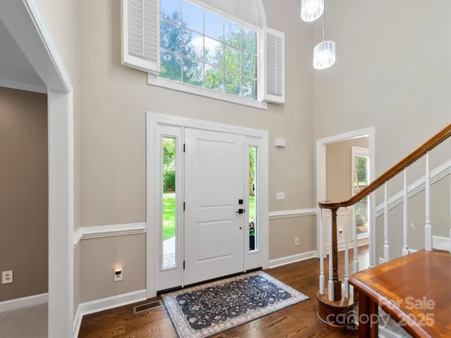 a view of entryway with a window and wooden floor