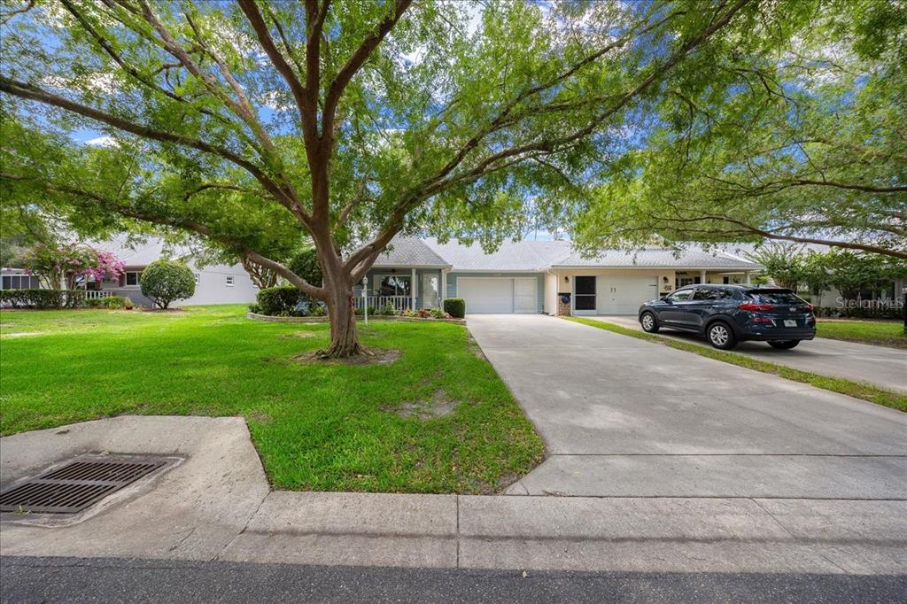 8720 Southwest 90th Street, Unit A Ocala, FL 34481 - Photo 8 of 71 a front view of a house with a yard and garage