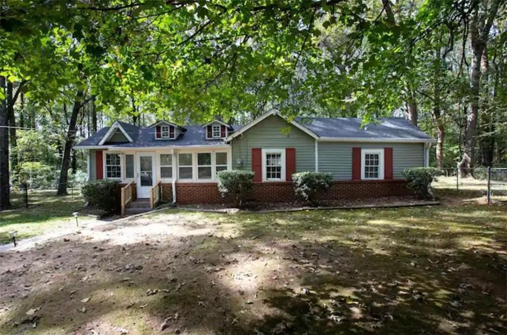 5232 Rock Springs Road Lithonia, GA 30038 - Photo 1 of 1 a front view of a house with a yard